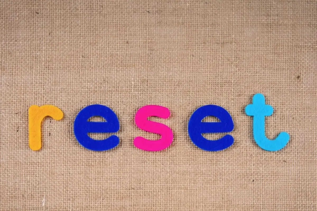 Colourful magnetic letters spelling the word reset on a linen background — a fresh start before IVF