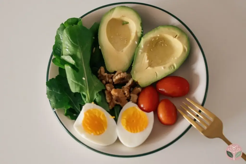 A plate of avocado, boiled eggs, walnuts, tomatoes and leafy greens: the Mediterranean-style foods linked to endometriosis
