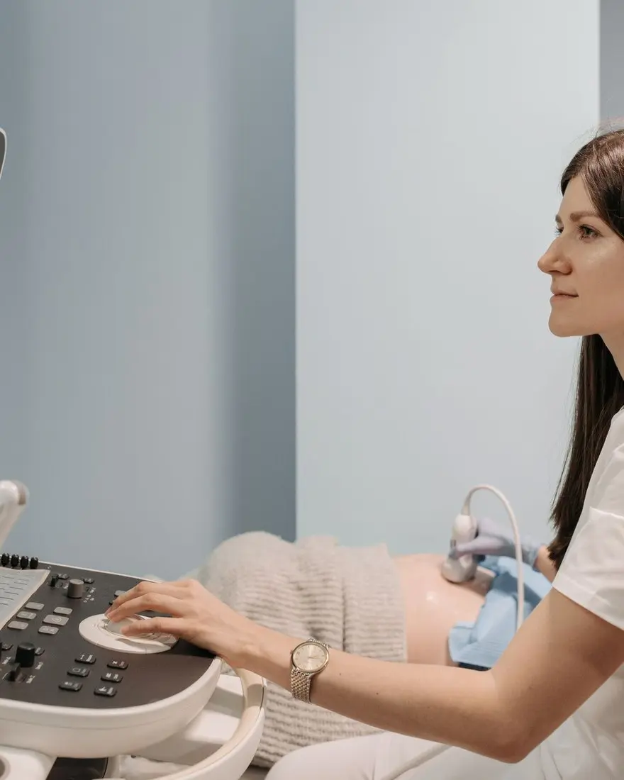 A female doctor performing an ultrasound scan in a calm clinic — specialist ultrasound is now the first step in diagnosing endometriosis
